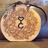 Custom-made bag with brand and floral carving.