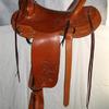 #0903; Modified Assoc. Tree, 12" swell, 15 1/2" seat, 4 1/2" cantle; Boy horn 2 1/2" high, 2 1/2" cap latigo wrapped; flat plate rigging, 3" leather-covered Visalia stirrups, partial flower carved.  