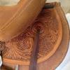 Indian Paintbrush carving on the rear fenders; leather bound Cheyenne roll.
