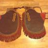 Kids chinks with brown & red rolled fringe, brand on the overlays.