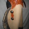 Tan with grey double fringe, floral carved overlays and conchos.