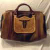 Dark & light brown hair-on bag, floral carved overlay with cut-out steer head, no side pocket.